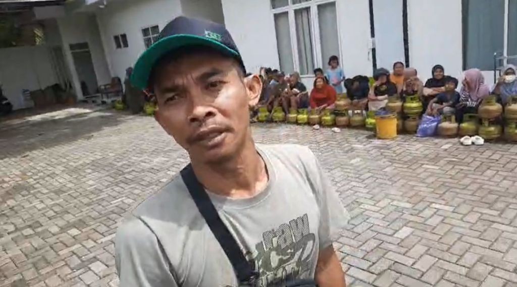 Malik, warga Arjosari, Pacitan, sedang diwawancarai oleh seorang reporter di tengah antrean gas Elpiji 3 kg.