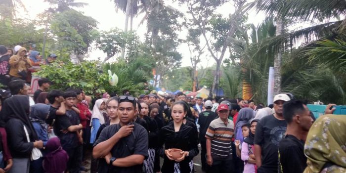 Warga saling lempar kelapa muda dalam puncak tradisi Ceprotan di Desa Sekar Pacitan.