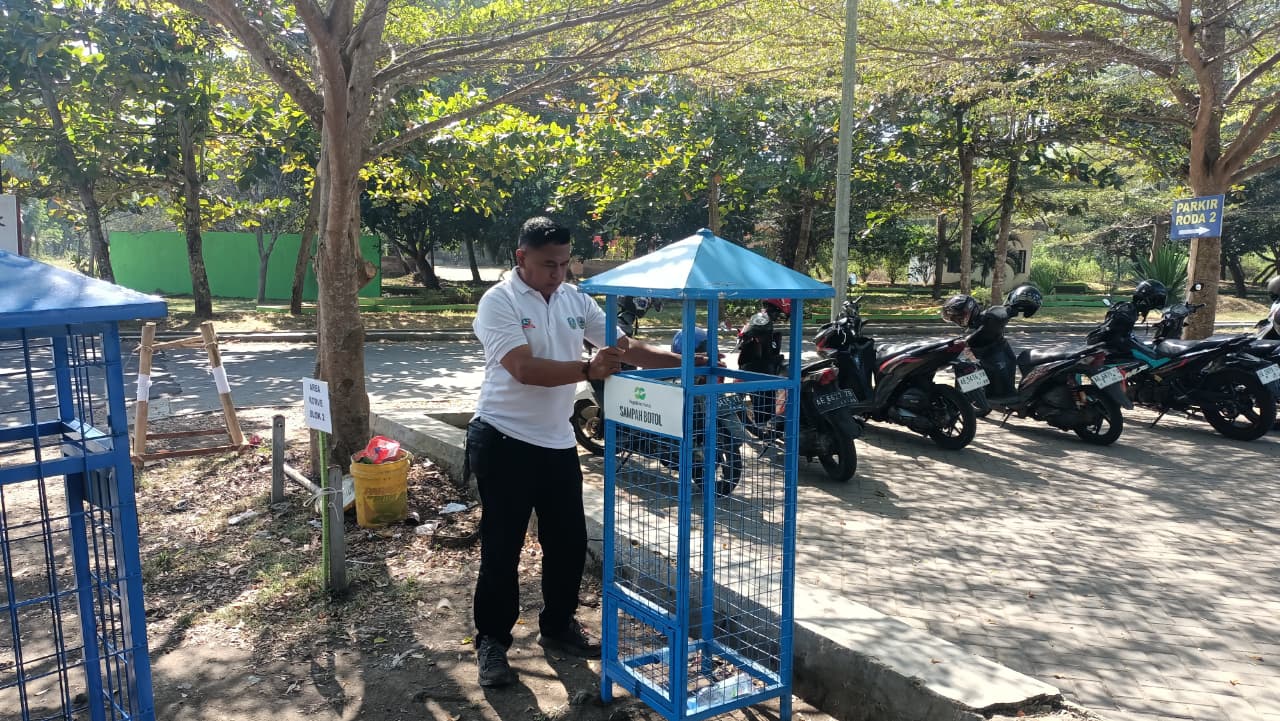 Petugas memasang keranjang khusus sampah botol di kawasan Alun-Alun Pacitan untuk edukasi pilah sampah masyarakat.
