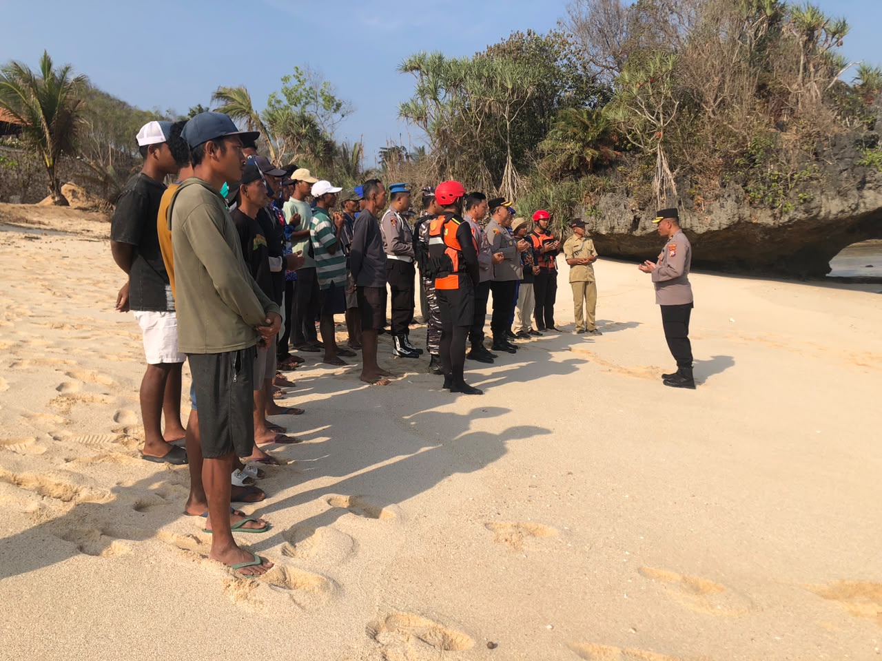 Anggota kepolisian, tim SAR gabungan, dan warga pesisir sedang memantau perairan dan menyisir area karang di Pantai Watu Murep, Pacitan, untuk mencari dua nelayan yang hilang.