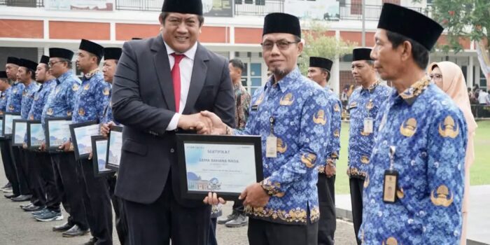 Wakil Bupati Pacitan Gagarin Sumrambah berjabat tangan dan menyerahkan sertifikat penghargaan Gema Bahana Nada kepada perwakilan ASN berseragam Korpri pada upacara Hari Sumpah Pemuda ke-98 di halaman Pendopo Kabupaten Pacitan.